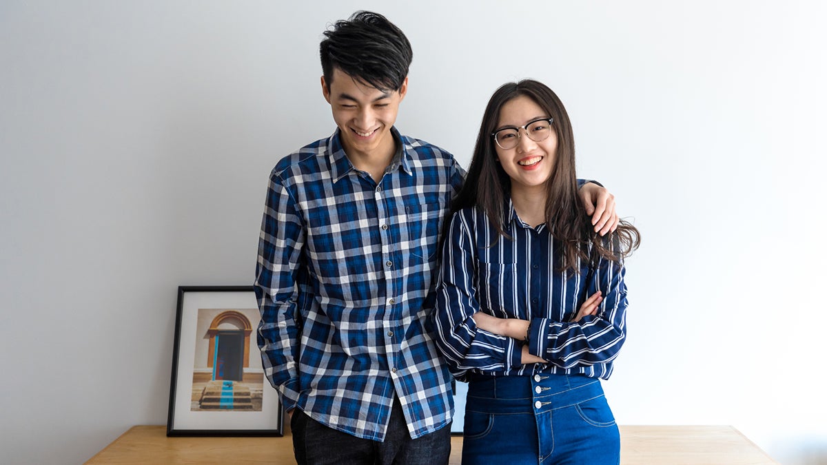<p>Millennial Asian couple smiling in the new home</p>